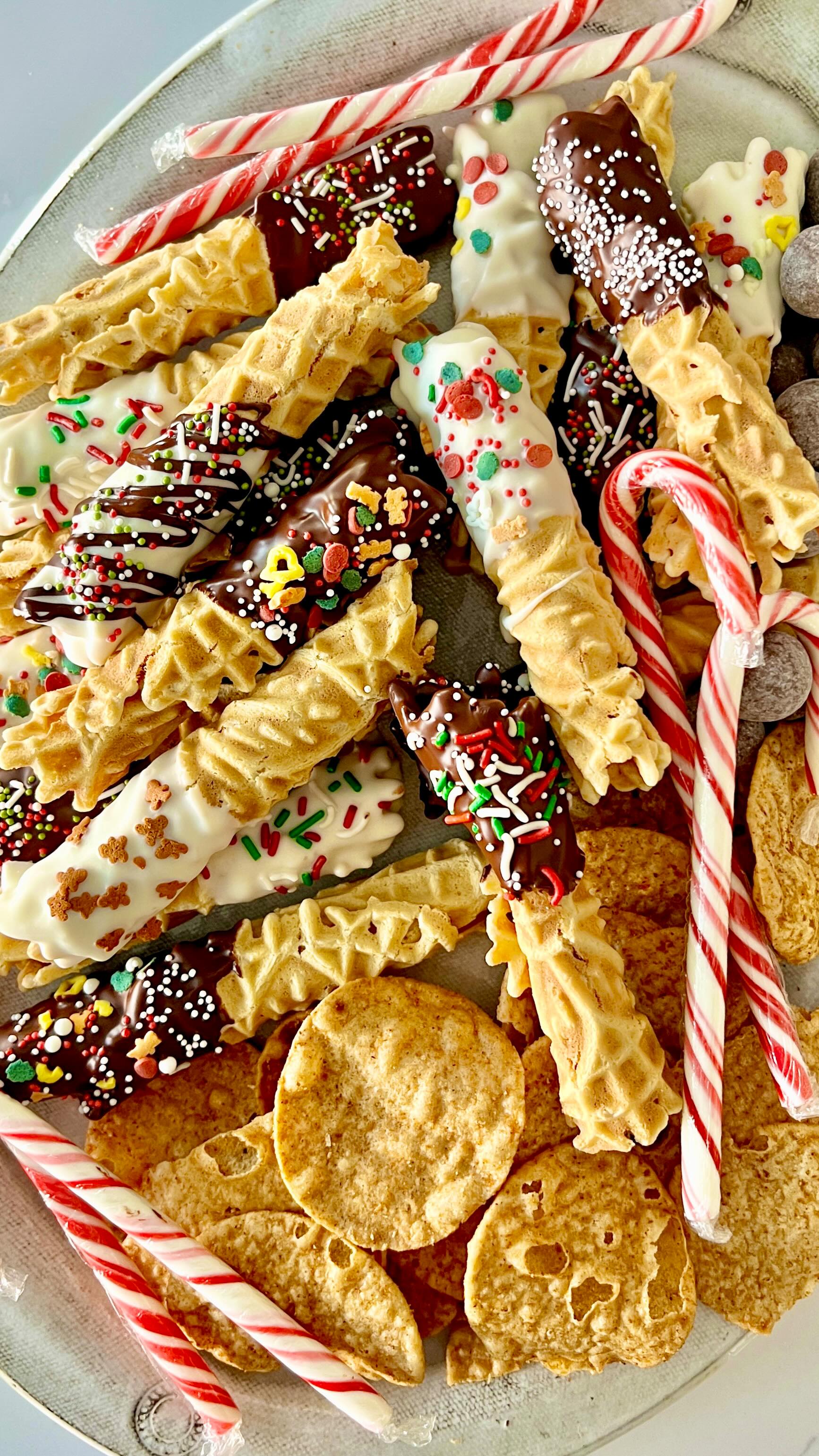 HOLIDAY SWEETS CHARCUTERIE - we’re all hosting or finding our way to all sorts of parties this time of year, so why not create a festive “sweet” charcuterie board!?
.
My PIZZELLES are so great to roll up & give a little dip in chocolate then adorn with sprinkles, chopped nuts or even crushed candy canes! While the PIZZELLE is still warm, immediately roll up & cool,  then dip, decorate & enjoy! 
.
Make a batch, decorate & freeze them so you’re ready to put this festive board together when it’s time to party! Add a few other festive finger foods & you’re ready to go!
.
For CHOCOLATE DIP: I like to melt 1 cup of dark chocolate chips or white chocolate chips + approximately 1-2 tsp coconut oil over a double broiler - this makes for a softer coating so they’re easier to eat. Pour that into a narrow heat proof jar/cup then you can dip the bottom half so easily!
.
Comment RECIPE if you’d like a DM with the direct link to my pizzelle recipe or find it over on @foodsocial.io via the link in bio! 

@ottosnaturals @amsalt.co @gosupernatural