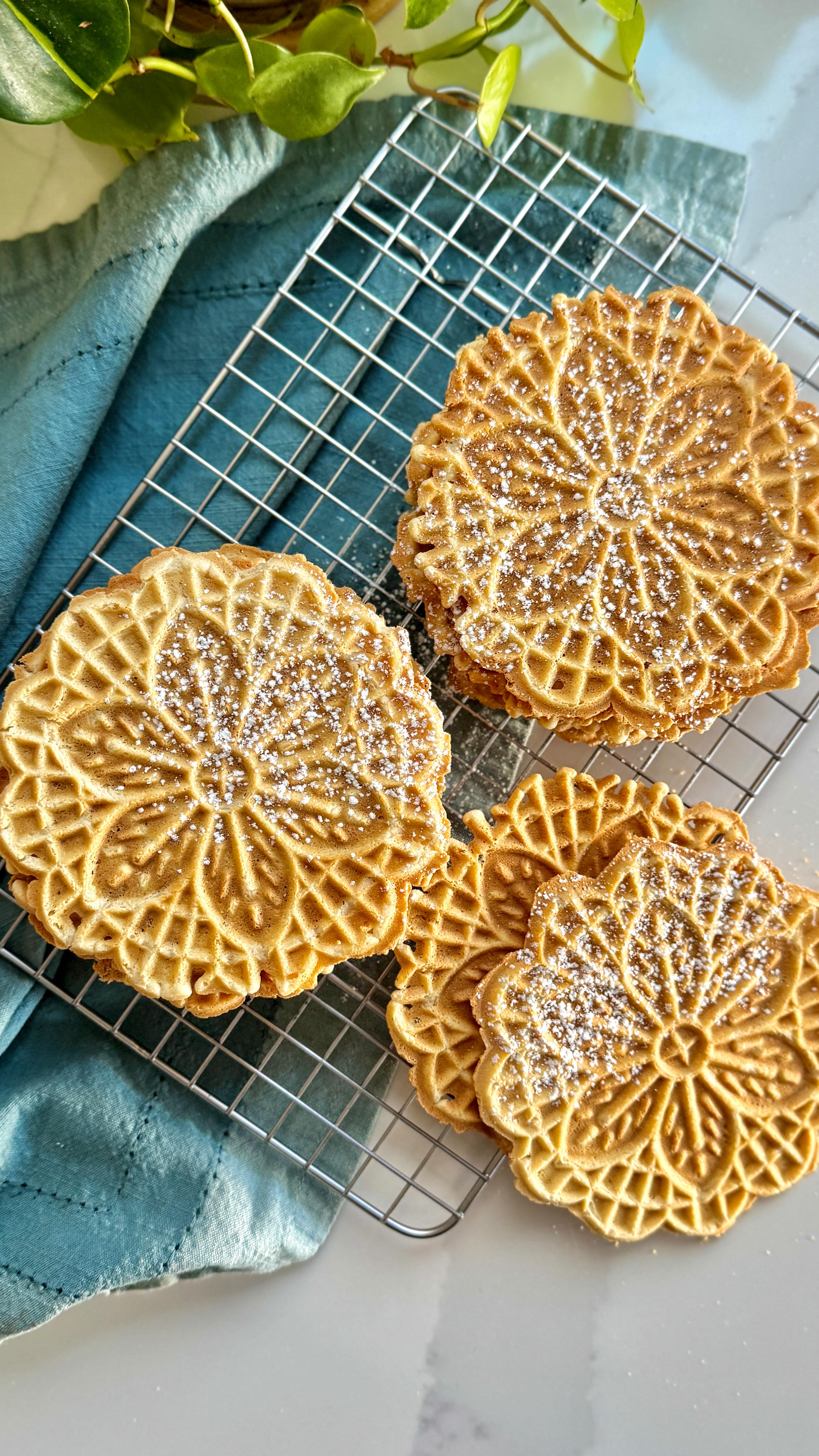 PIZZELLES for the festive holiday season! I’ve been making these treasures for over a decade & they’re just as enjoyable as ever.
.
A thin waffle like cookie with hints of vanilla that will make any dessert or brunch table truly magical.
.
Perfect for gifting too as everyone is always so smitten with how pretty they are & most definitely delicious!
.
gluten, dairy & nut FREE!
.
Did you catch how you can “trim” them up in the event they don’t come out perfectly? 
.
Comment: RECIPE & the direct link to the recipe will arrive via a DM, otherwise find this one via the link in bio over at @foodsocial.io
.
https://foodsocial.io/recipe/pizzelle-paleo-gluten-free/
@ottosnaturals @amsalt.co